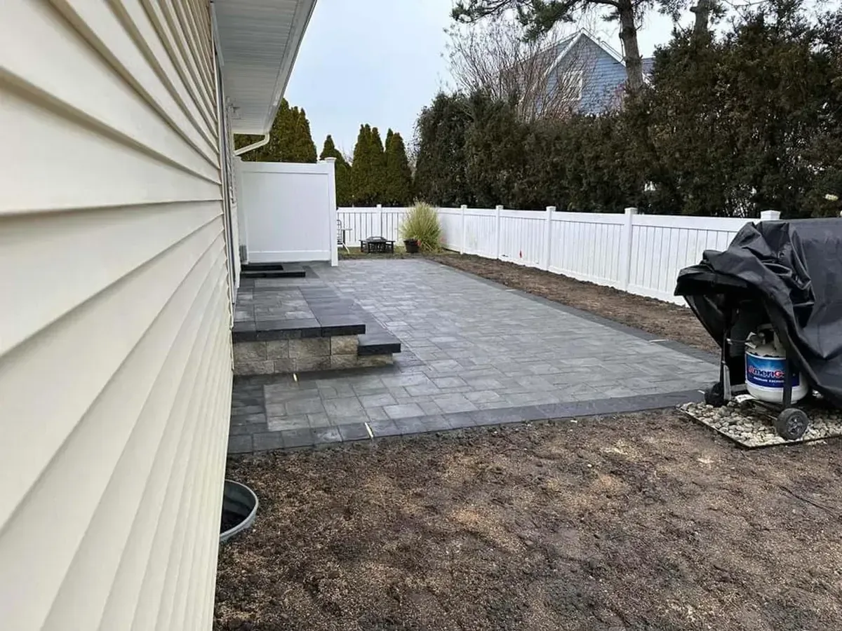 Backyard paver patio with steps and privacy fencing in Chester County PA