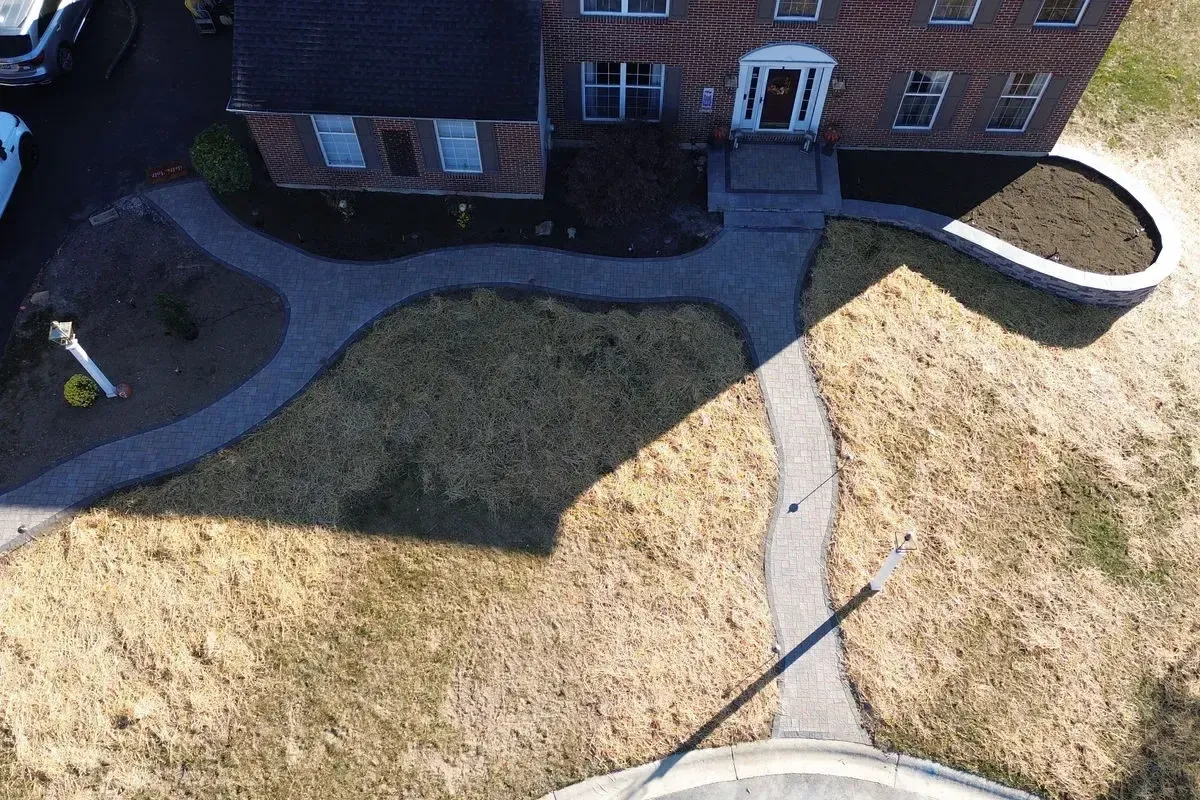 Aerial paver driveway and front walkway with curved retaining wall Chester County PA