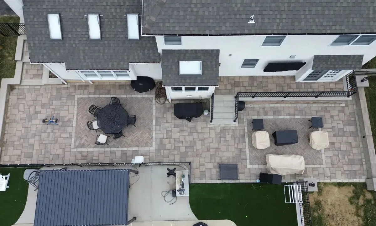 Aerial view of multi-level paver patio with pergola and herringbone pattern Chester County PA