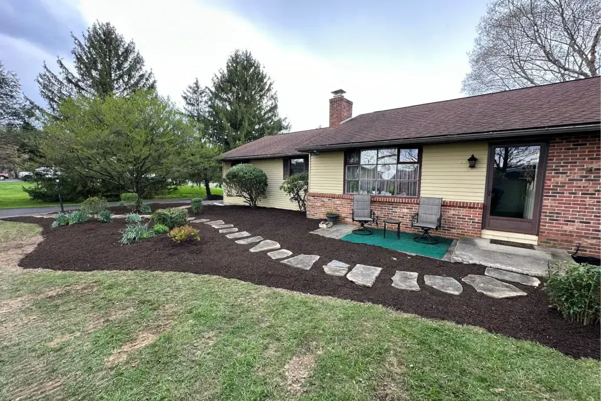 Natural flagstone stepping stone path through mulch beds with plantings in Chester County PA
