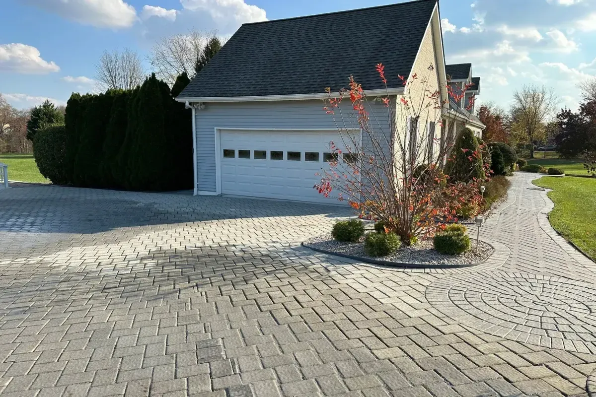 Custom paver driveway with circular detail and herringbone pattern in Chester County PA