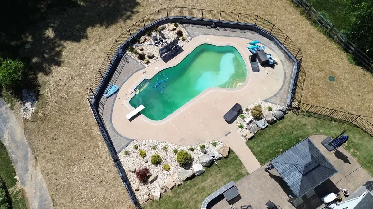 Pool deck with stamped concrete boulder edging and gazebo in Chester County PA